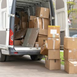 Open,Lorry,Car,Trunk,With,Moving,Cardboard,Packages,Outdoors.,White